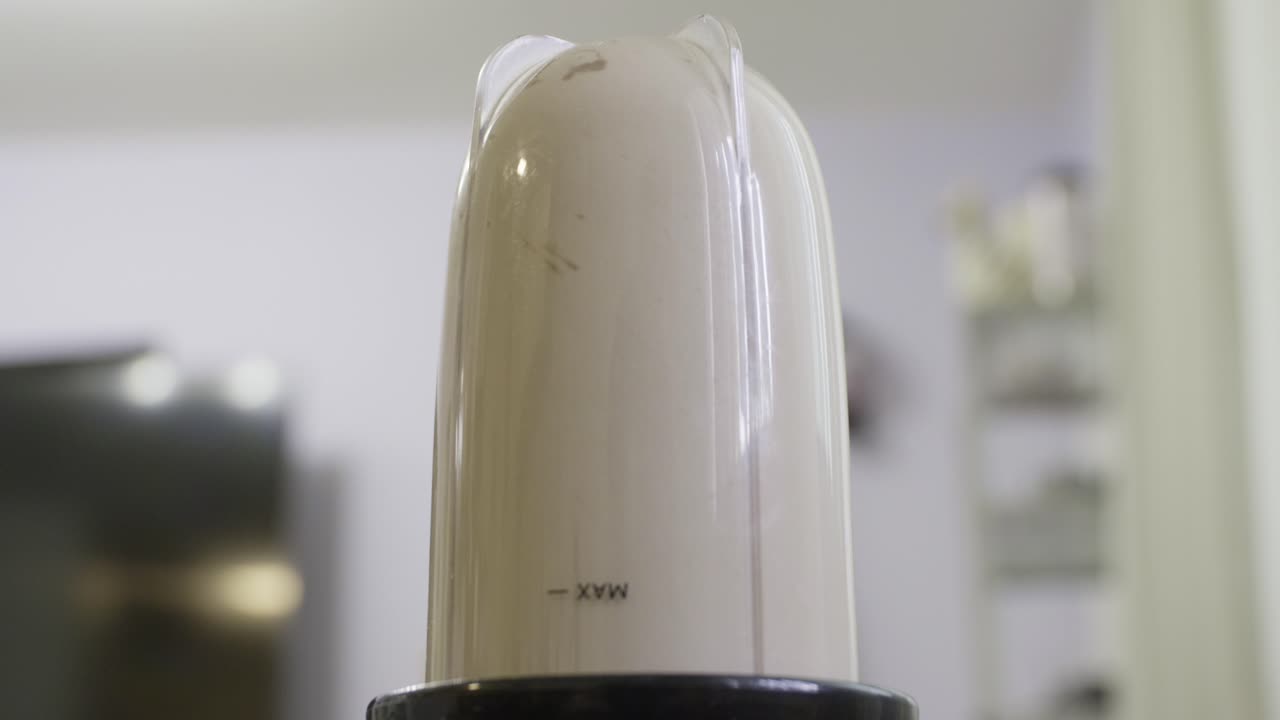Close up of blender mixing a protein shake, smoothy. Mixer making post workout shake