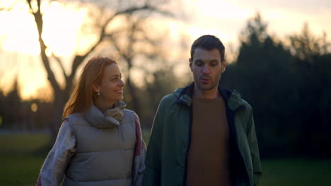 A couple walking in the park during sunset
