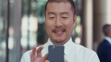 portrait of japanese businessman outside corporate office building