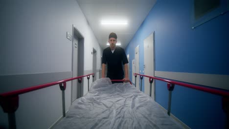 doctor pushing a stretcher in a hospital corridor