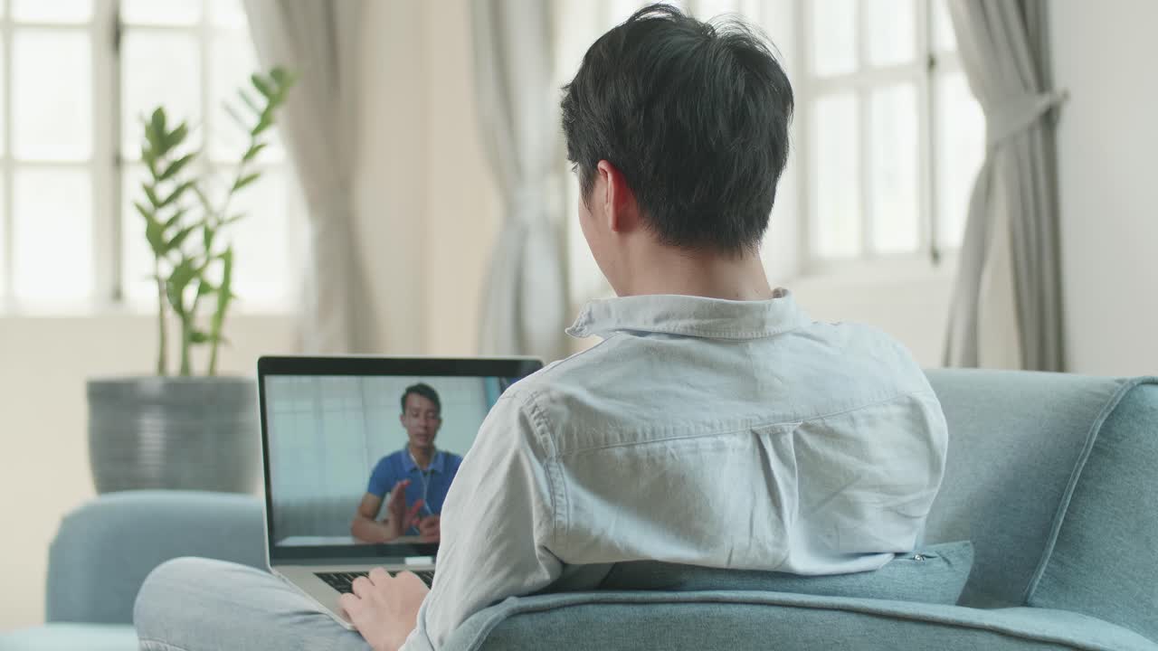 Man Video Conference Call From Laptop At Living Room, Video In 4K