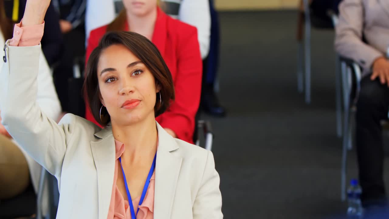 Businesswoman raising hand in the business seminar 4k