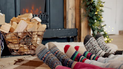 family cozying up by the fireplace