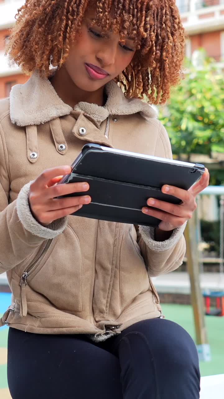Woman using tablet in urban park