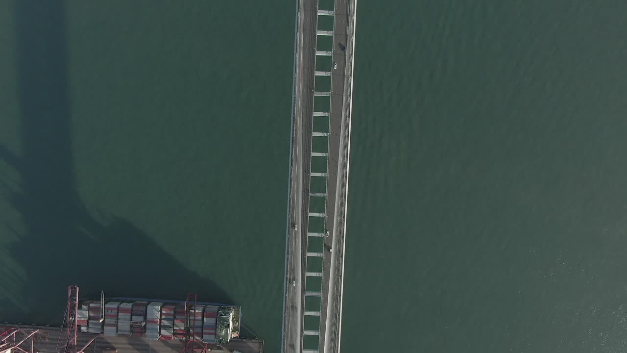 Hong Kong Stonecutters bridge and Container terminal and port at Victoria bay including storage terminal, Aerial footage