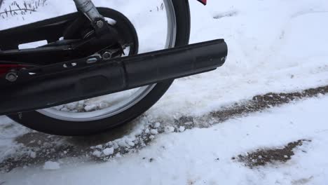 Retro-moped-making-wheel-spin-on-ice