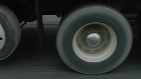 tracking shot alongside a trucks wheels traveling along a freeway.