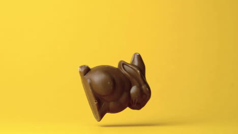 Chocolate-bunny-falling-against-yellow-background