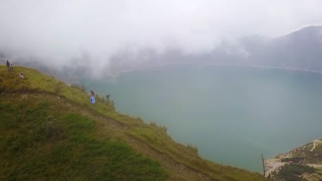 a beautiful woman runs along the rim of a volcano and cone at quilotoa ecuador 1