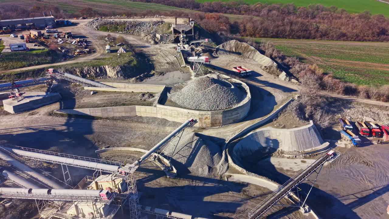 Massive gravel operation in a serene landscape showcasing equipment and nature meeting industry