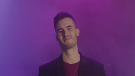 Portrait-Of-A-Young-Man-Smiling-And-Looking-At-Camera-At-Disco