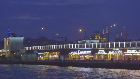 night view of galata bridge and new mosque in istanbul, turkey