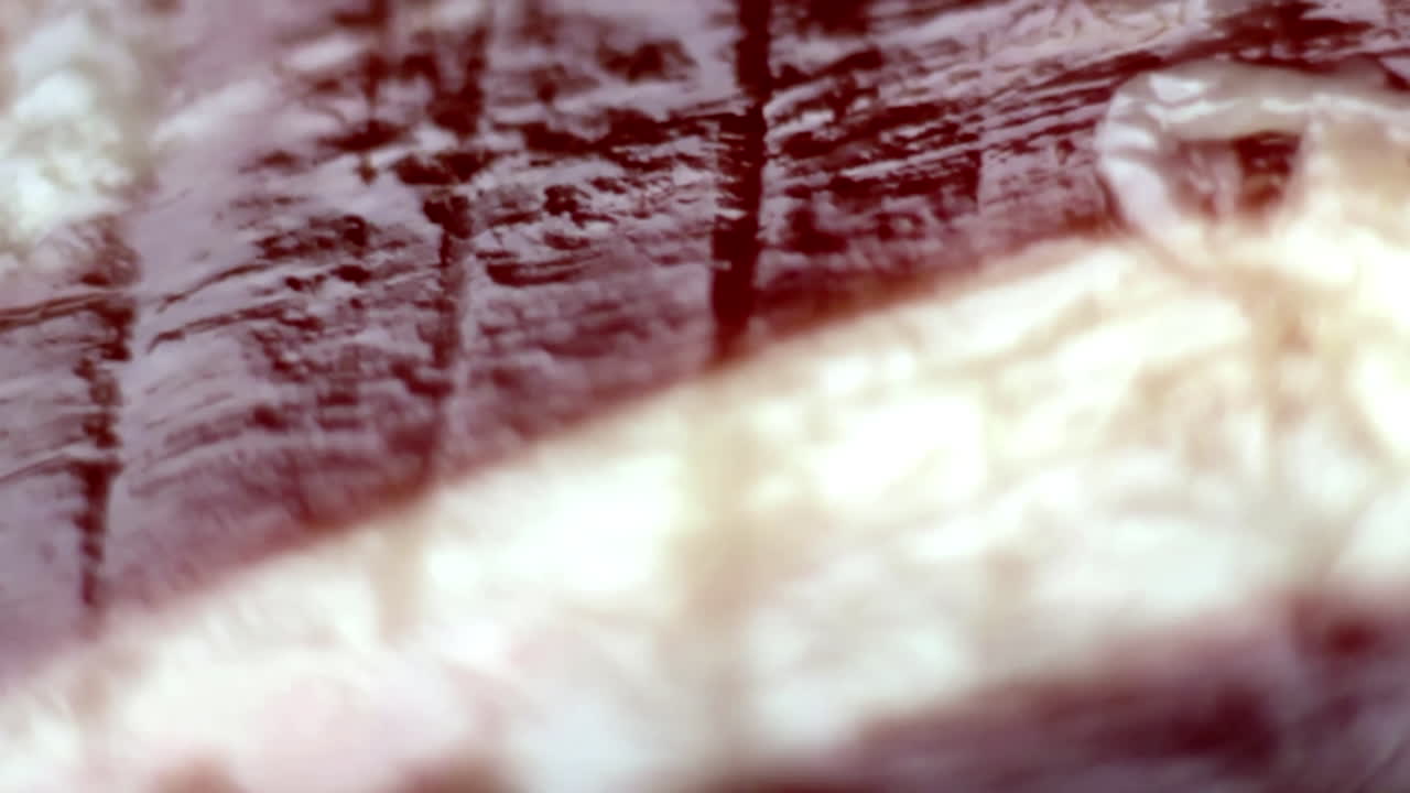 Extreme close-up of dry-cured Spanish ham showcasing its rich marbled texture and deep color