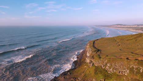 Panoramic-aerial-view-of-cliffs-on-atlantic-ocean-at-sunrise,-Guarita-Park,-Brazilian-Conservation-Unit,-of-Rio-Grande-do-Sul,-Torres-City