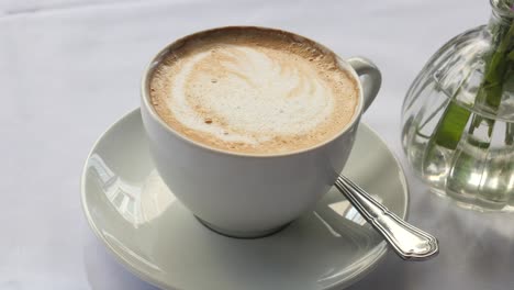 cup of cappuccino with vase