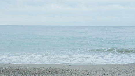 gentle ocean waves caressing beach shore on a tranquil grey morning