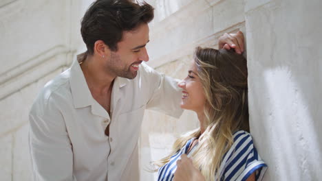 affectionate couple flirting together at urban street closeup. happy lovers date