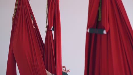 concentrated-women-group-relaxes-in-fly-yoga-hammocks