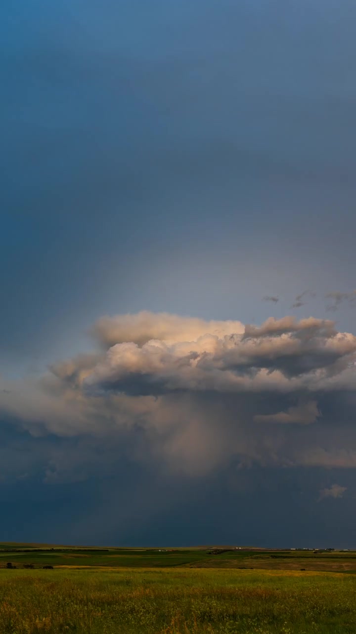 Warm sunset sky glowing behind dark clouds in a moody evening scene