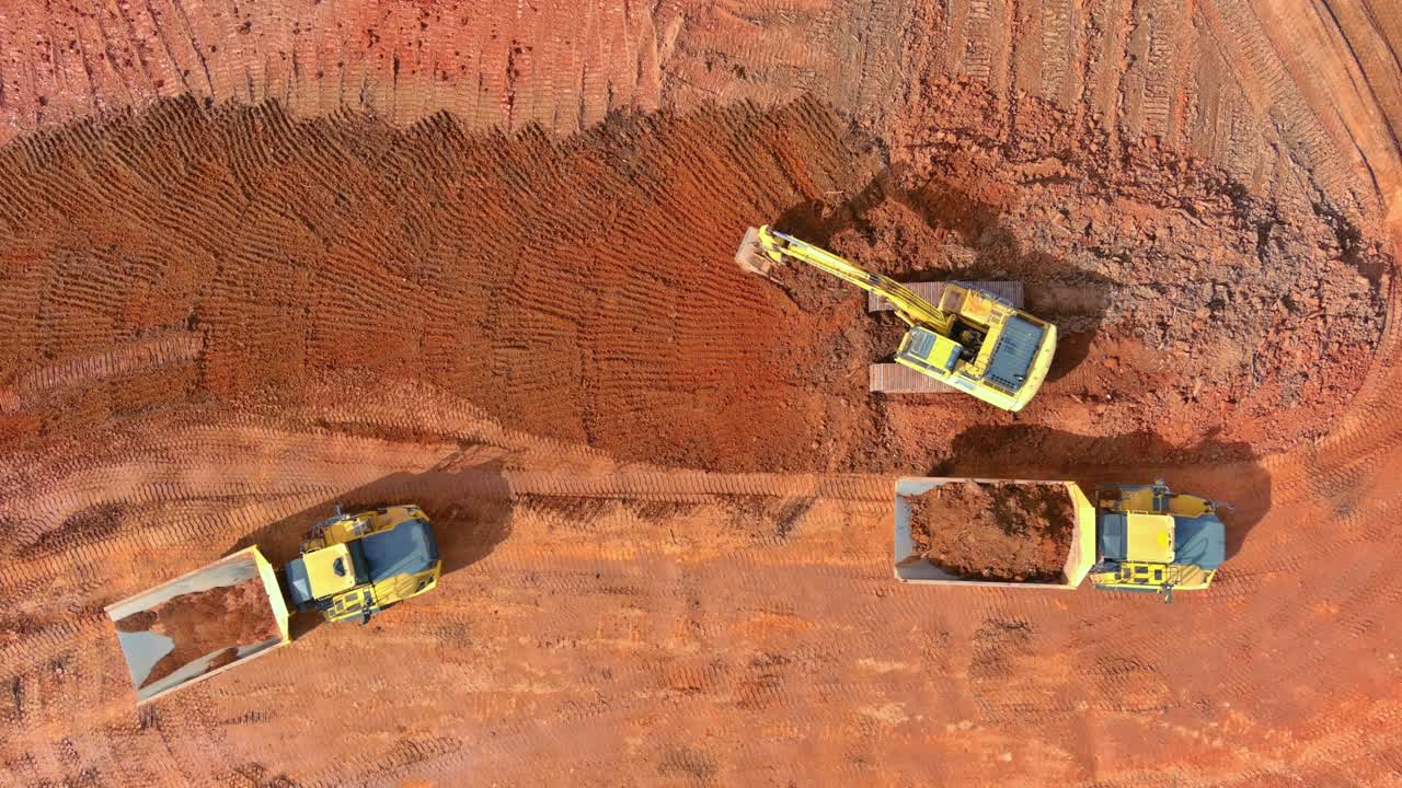 Top aerial view excavator truck are loading soil a dump truck