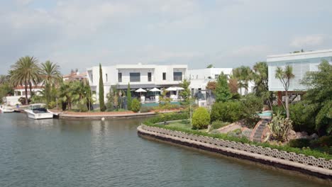 tourist woman looking at the scenic empuriabrava, a residential marina in castelló d'empúries, spain - panning shot