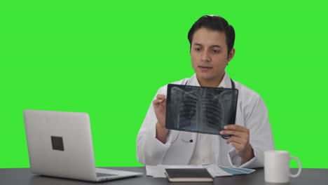 Happy-Indian-doctor-checking-the-X-ray-report-Green-screen