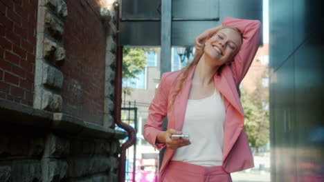 woman in pink suit in urban setting
