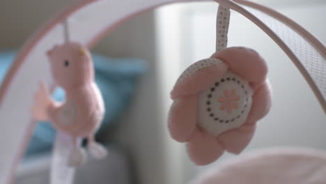 baby toys hanging over the bassinet and swinging