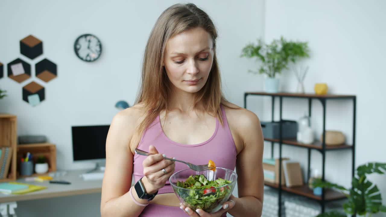 Woman Eating Salad in Home Office