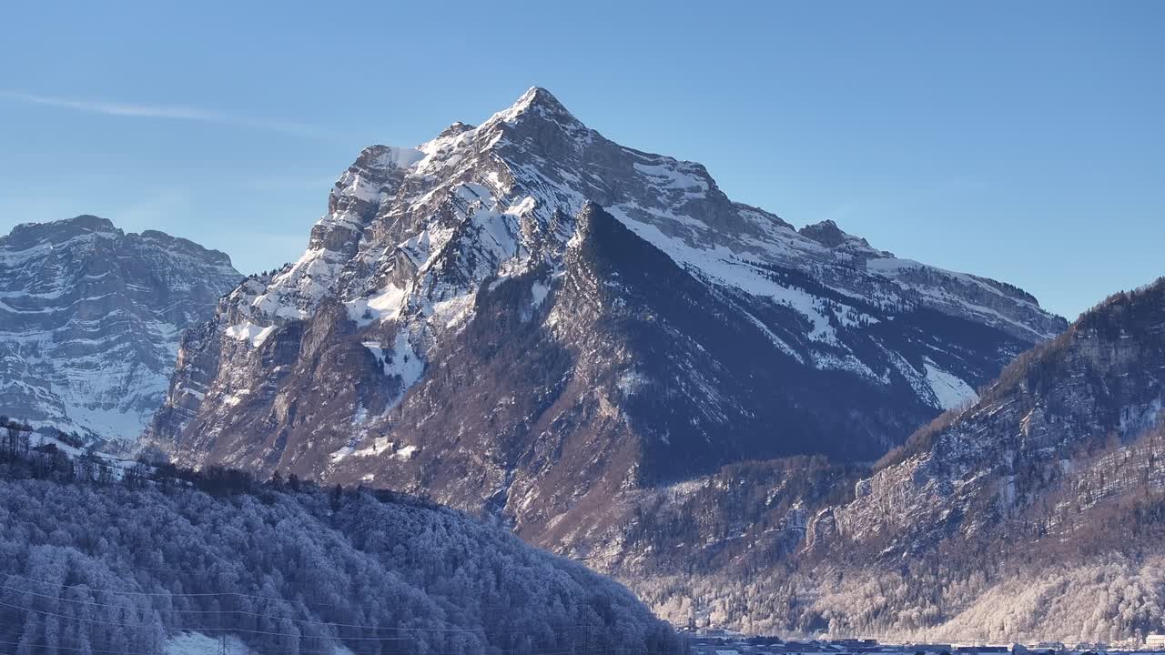 Aerial view of the majestic Rautispitz mountain in Switzerland, showcasing its snow-capped peak and its dramatic presence in the landscape.