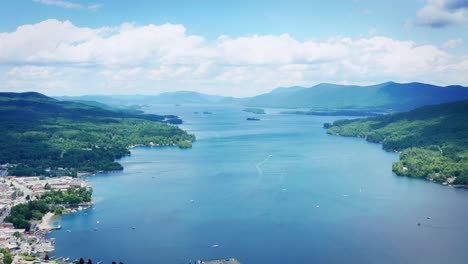 slow pull back with a drone over lake george and the town of lake george, new york