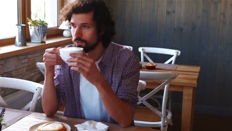 man having coffee in cafe