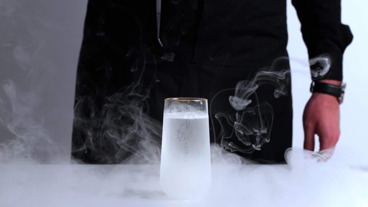 Finished gin tonic with ice, bubbles, and garnish