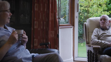 elderly man relaxing in armchair at home