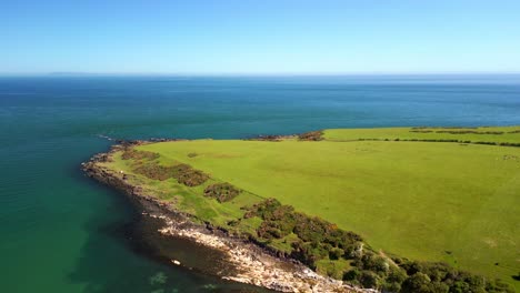 wide overhead aerial video of brown's bay in county antrim, northern ireland, uk on a bright and sunny day. filmed in 4k, 60fps and with rec709 color.