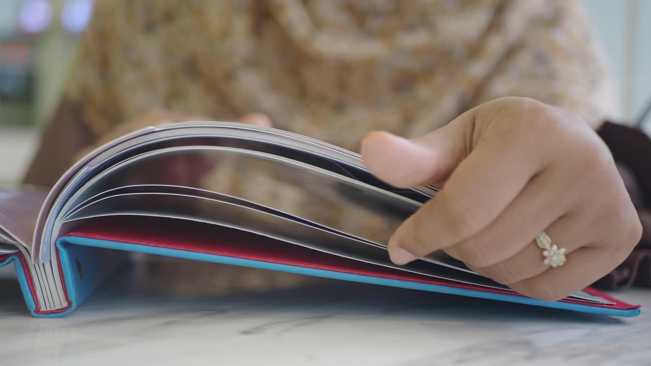 Person Flipping Through a Photo Album