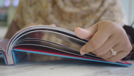 person flipping through a photo album