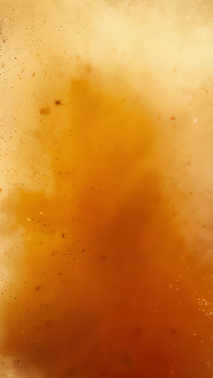 Vertical video: Sudden eruption sending orange dust cloud expanding outdoors, dispersing particles