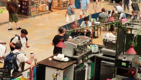 people buying coffee at a bustling cafe