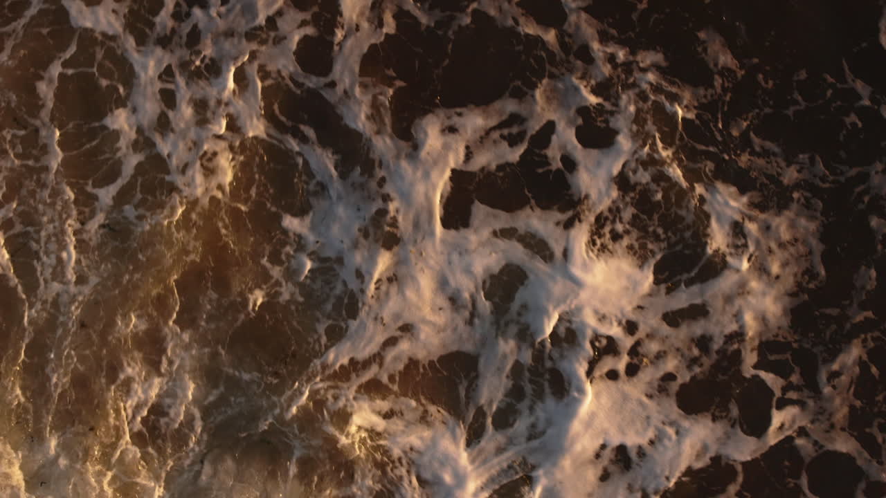 Golden Ocean Waves at Sunset: Aerial View