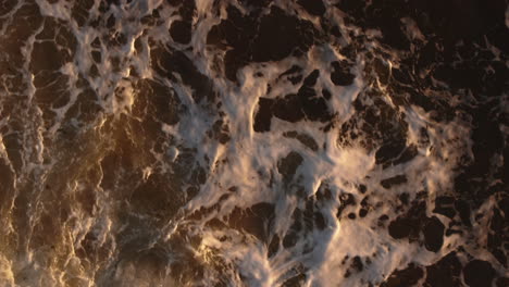 golden ocean waves at sunset: aerial view
