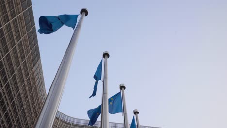 European-Flags-Waving-In-The-Wind-In-Front-Of-Berlaymont-Building-In-Brussels,-Belgium