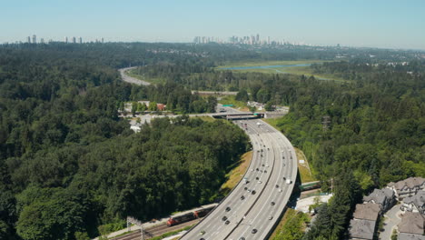 aerial drone view over the trans-canada highway in burnaby with the vancouver skyline in the distance