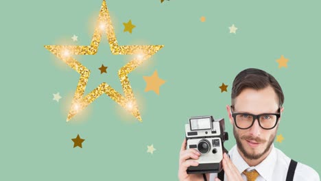 animation of smiling man holding retro camera moving over christmas decoration with stars on green