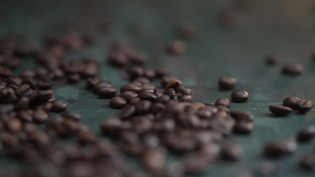 Dolly right of coffee beans on the dark green background