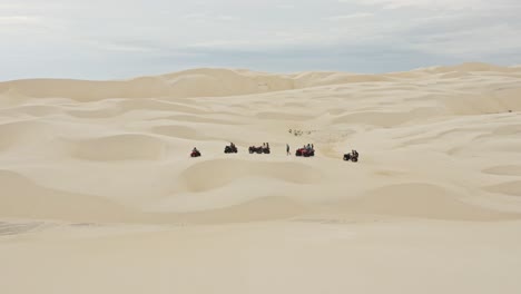 Group-on-ATV-vehicles-parked-in-Brazil-desert-sand-dune-landscape