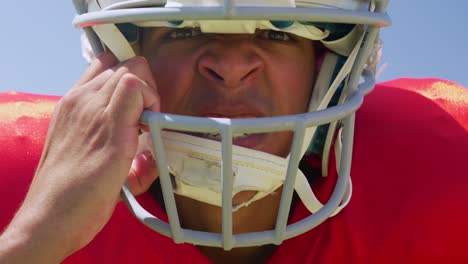 american football player standing with helmet