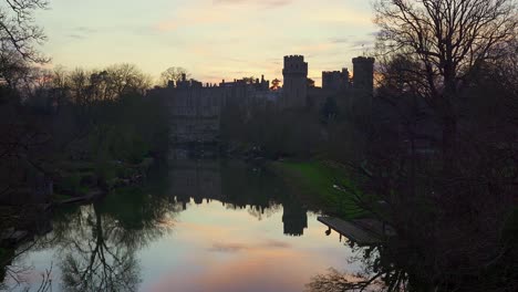 warwick castle and avon river river during winter sunset