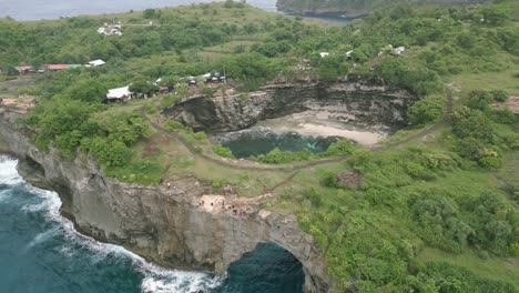 ocean landscape on nusa penida island broken beach bali indonesia natural pool with green tropical cliffs arch crystal clear turquoise sea water