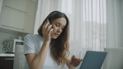 angry woman call phone at home. annoyed person talking mobile phone at kitchen